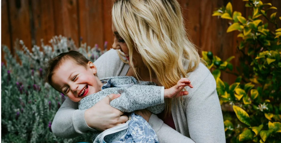 woman holding young child 