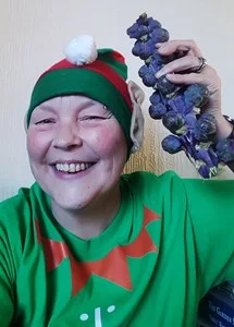 a woman living with a stoma dressed up in an elf costume